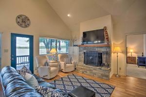 a living room with a couch and a fireplace at Private Dock and Fire Pit Cedar Creek Lake Home in Eustace
