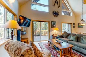 a living room with a couch and a table at Serene Family Cabin in Soda Springs