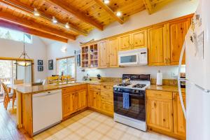 a kitchen with wooden cabinets and a stove top oven at Serene Family Cabin in Soda Springs