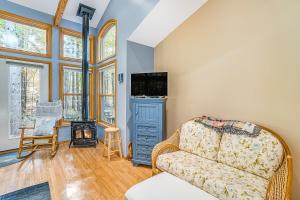 a living room with a couch and a tv at Saltbox in Thompsonville