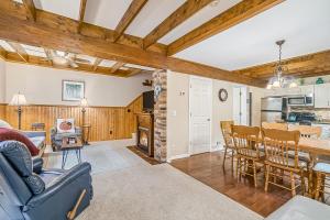 a living room with wooden ceilings and a dining room and kitchen at Saltbox in Thompsonville