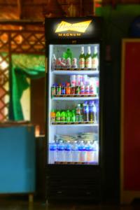 a refrigerator filled with lots of sodas and drinks at Megha Resort , Hampi in Hampi