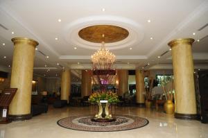a lobby with a vase of flowers on the floor at The Katerina Hotel in Batu Pahat