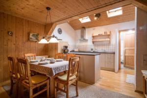 cocina y comedor con mesa y sillas en Bergbauernhof Hinterseebach, en Oberaudorf