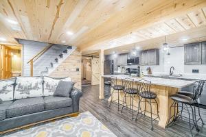 a living room with a couch and a kitchen at Betsie River Getaway in Thompsonville