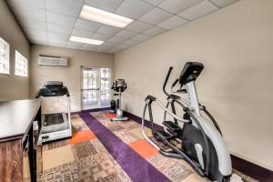 a fitness room with a treadmill and exercise equipment at Inn of Naples, Tapestry Collection by Hilton in Naples