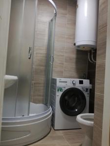a bathroom with a washing machine and a washer at STAN na DAN PEX FREE PARKING in Vranje