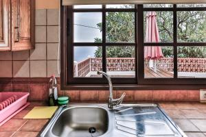 a kitchen sink and a window with a view of a balcony at CASA VILA in Garafía