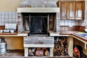 a kitchen with a brick oven with logs in it at CASA VILA in Garafía