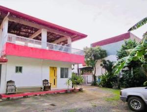 a house with a red and white at Perlies Inn Balcony House in Tanay