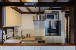 a kitchen with a microwave oven and a sink at Duplex Chamonix Les Grands Montets in Chamonix