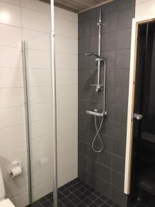 a bathroom with a shower with a glass door at Apartment Starvillas Kalajoki in Kalajoki