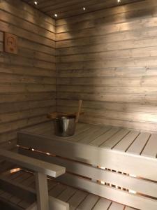 a small wooden sauna with a bucket in it at Apartment Starvillas Kalajoki in Kalajoki