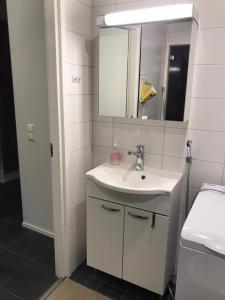 a white bathroom with a sink and a mirror at Apartment Starvillas Kalajoki in Kalajoki