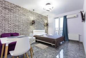 a bedroom with a bed and a brick wall at Апартаменти "Kopernik" in Kyiv