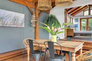 a dining room with a wooden table and chairs at Lazenby Lodge in Edge Hill