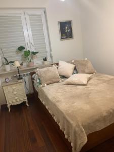 a bedroom with a bed and a table with a window at Apartament Stylowy Pruszków Centrum in Pruszków