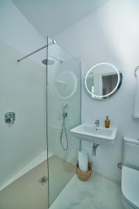 a bathroom with a shower and a sink and a mirror at Vila Alaró TI in Alaró