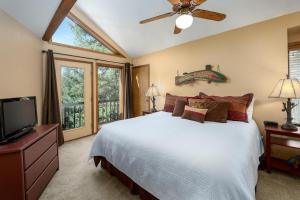 a bedroom with a bed and a flat screen tv at Heartstone Hideaway in Breckenridge