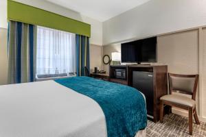 a hotel room with a bed and a television at The Freeport Hotel, Ascend Hotel Collection in Freeport