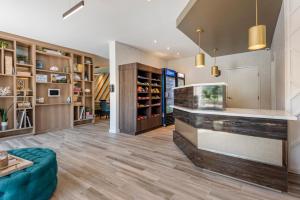 a large living room with a fish tank in the center at The Freeport Hotel, Ascend Hotel Collection in Freeport