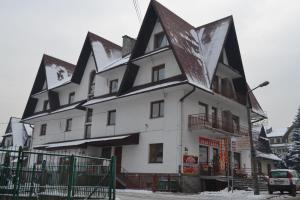 a large white building with a black roof at U Lampy in Zakopane