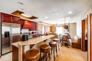 a kitchen with a counter and some bar stools at Condos at Canyons Resort by White Pines in Park City