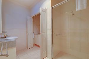 a bathroom with a shower and a sink at Traralgon Serviced Apartments in Traralgon