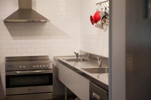 
a kitchen with a stove top oven and a sink at Burncroft Guesthouse in Lovedale
