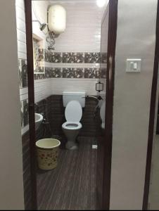 a bathroom with a toilet and a sink at Avvairam Service Apartment - C9 in Chennai