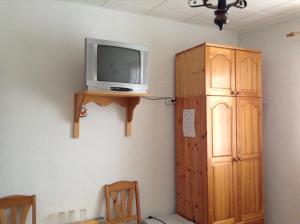 a room with a tv and a wooden cabinet at Guest Rooms Toni & Miro in Tryavna +27 photos