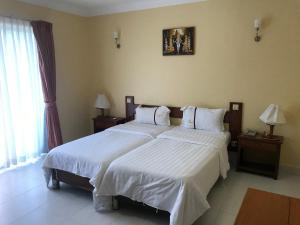 
A bed or beds in a room at Don Bosco Hotel School
