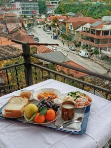 a tray of food on a table with a view of a city at Ensol B&B in Peshkopi