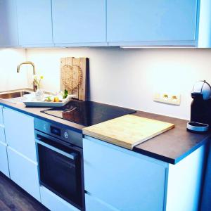 a kitchen with blue cabinets and a counter top at Mijn Rust in Jabbeke