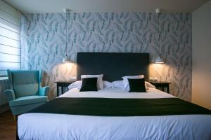 Łóżko lub łóżka w pokoju w obiekcie Hotel Spa Sinagoga