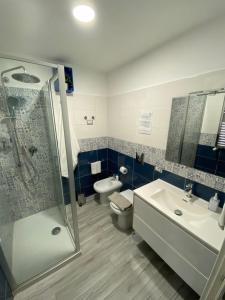 a bathroom with a shower and a sink and a toilet at La CasAffittiera Apartments Group in Anzio +91 photos