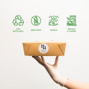 a hand holding a brown box with four different symbols at Hotel Holiday La Marca in Villorba