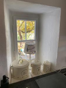 a kitchen with three crock pots and a window at Bauernhaus am Sallingbach in Sallingberg