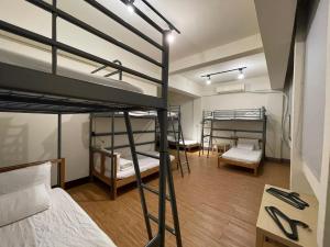 Voodi või voodid majutusasutuse Chiayi Petite Hostel toas