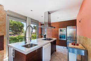 a kitchen with a sink and a stove at 206 Villa Isabel ET2341 by Mallorca Charme in Alcudia