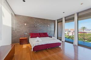 a bedroom with a large bed with red pillows at 206 Villa Isabel ET2341 by Mallorca Charme in Alcudia