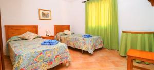 een slaapkamer met 2 bedden en groene gordijnen bij 414 Finca Can Crestall VT1725 by Mallorca Charme in Campos +24 foto's