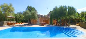 a swimming pool in front of a house at 411 Finca Sa Costa ETV1976 by Mallorca Charme in Campos