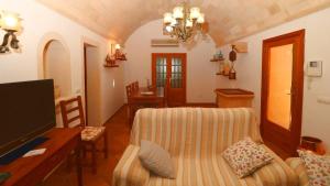 a living room with a couch and a tv at 411 Finca Sa Costa ETV1976 by Mallorca Charme in Campos