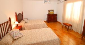 a bedroom with two beds and a table and a window at 411 Finca Sa Costa ETV1976 by Mallorca Charme in Campos +28 photos