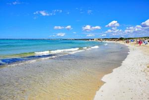 a group of people walking on the beach at 409 Villa Can Bril ETV1523 by Mallorca Charme in Campos