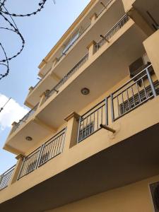 a building with balconies on the side of it at Immeuble SOUKO in Bamako