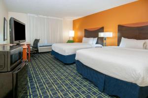 A bed or beds in a room at Quality Inn & Suites