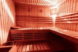 an empty wooden sauna with a bench in it at Fogajard Lovely Chalet in Madonna di Campiglio