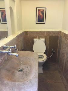 W łazience znajduje się umywalka i toaleta. w obiekcie Panchkote Raj Ganges w mieście Waranasi